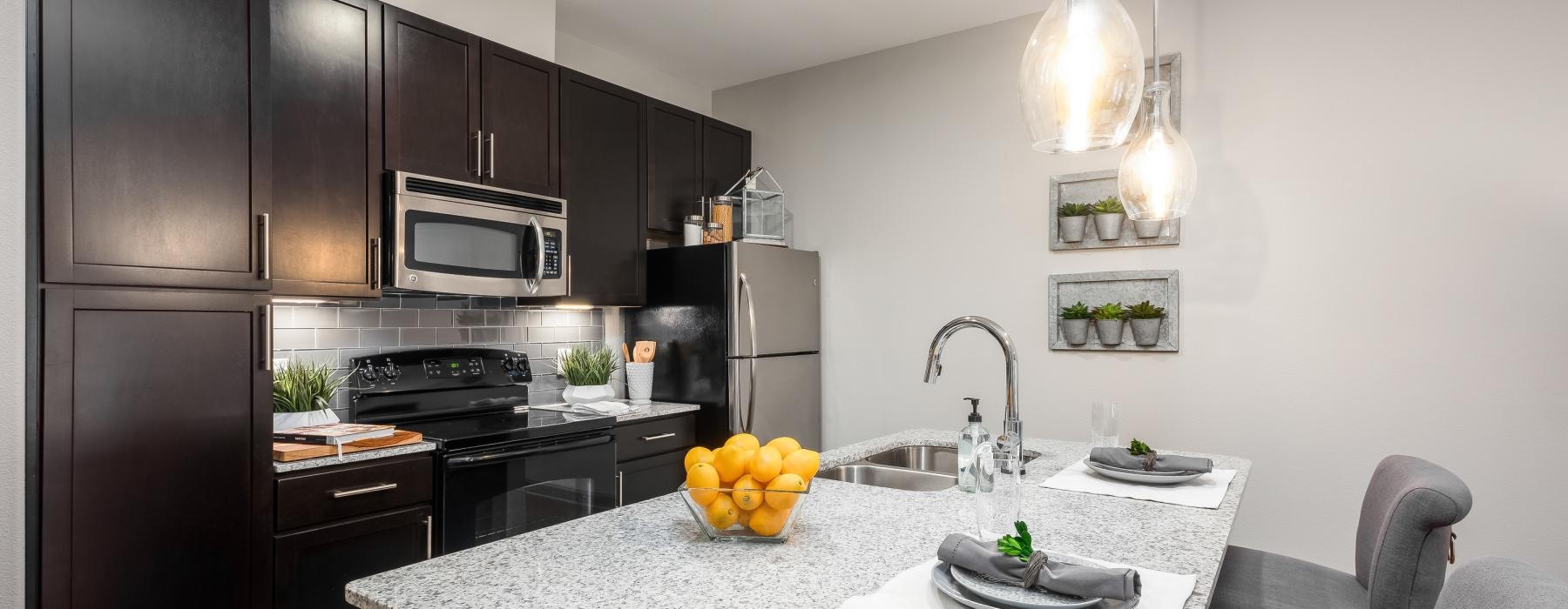 a kitchen with black cabinets